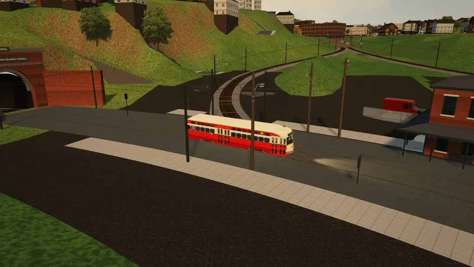 A cream and red PCC at South Hills Junction beside the tunnel portal and the station building